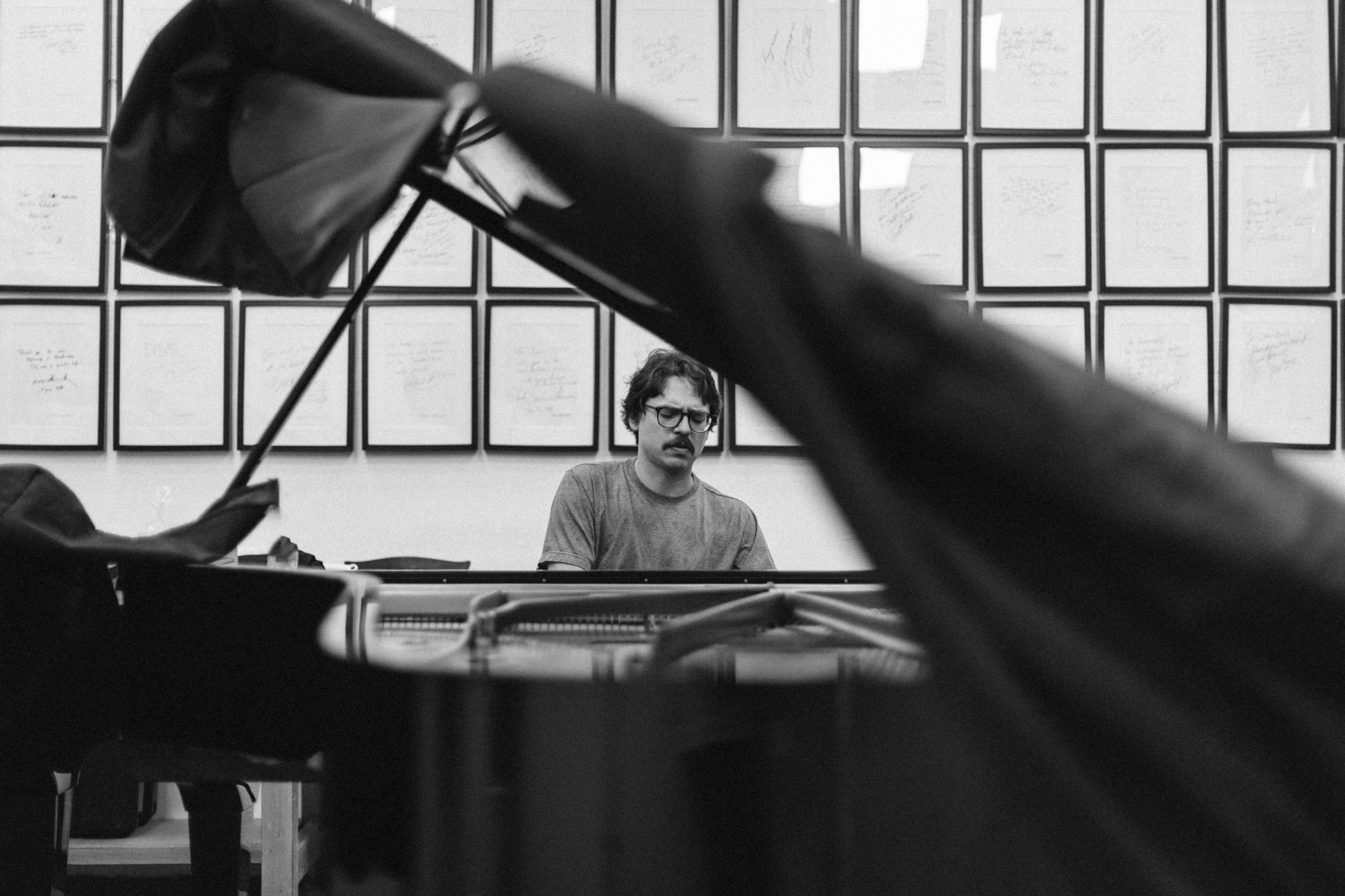 Le pianiste Lucas Debargue au choix de piano dans l'atelier d'accordeurs Pianomobil, photographié par Valentine Chauvin au Festival de Piano de la Roque d'Anthéron en juillet 2024